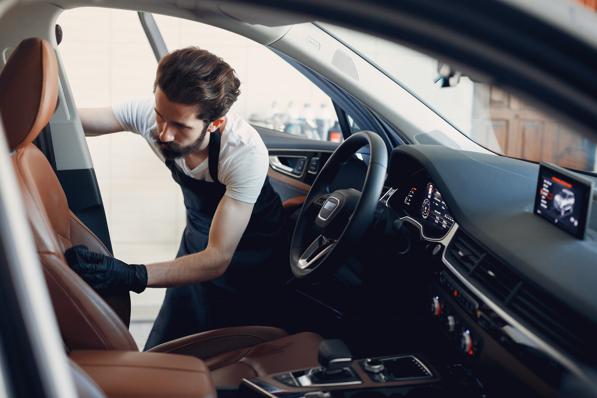 man-washing-his-car-garage_1157-26072